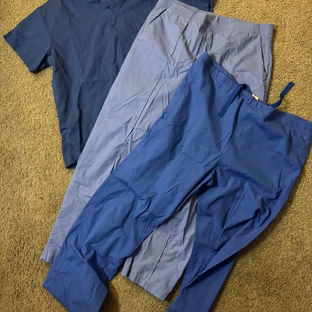 Blue scrub set with matching top and two pairs of pants, all size M